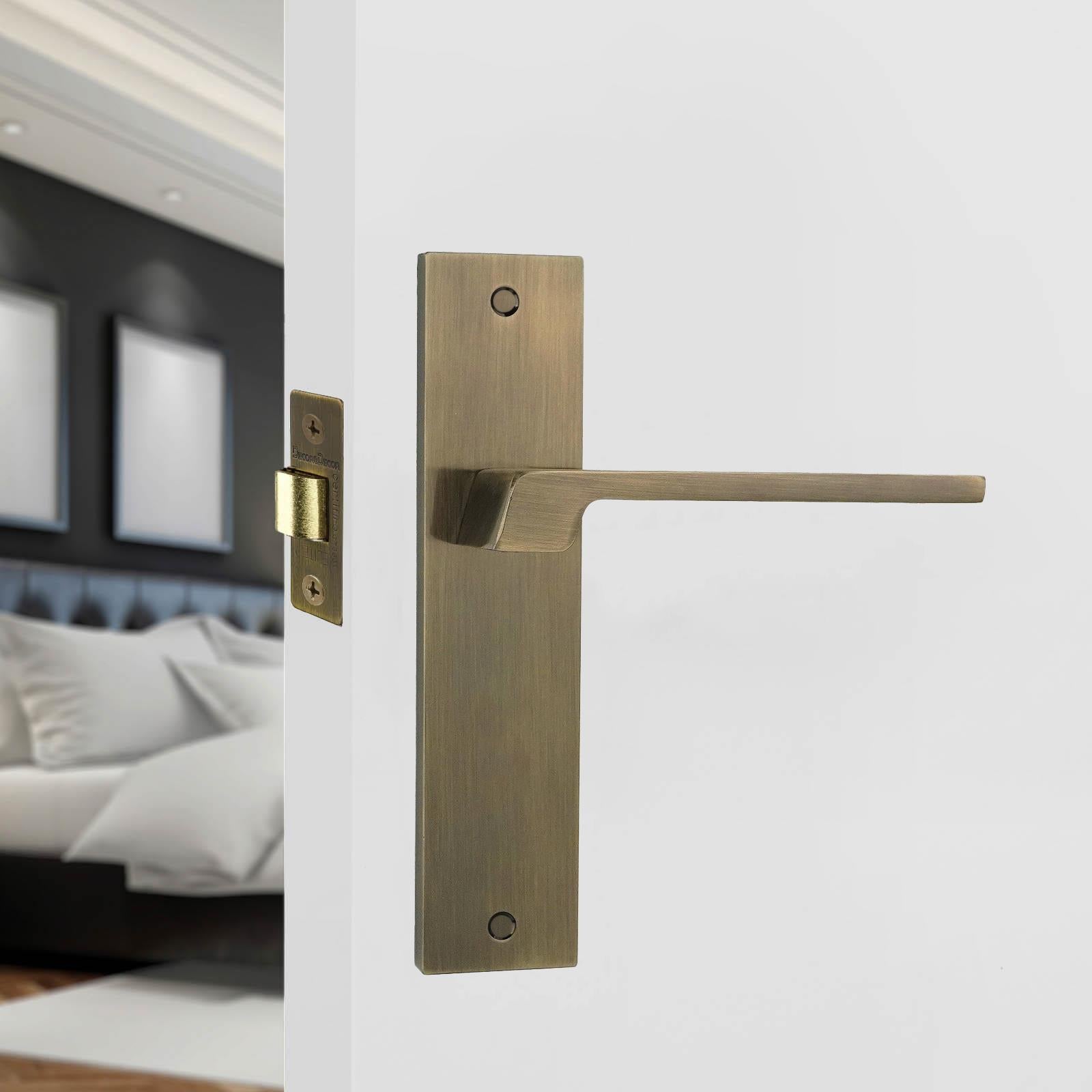 Spectra Antique Brass Passage Door Handles on Backplate - Latch and Hinge Set