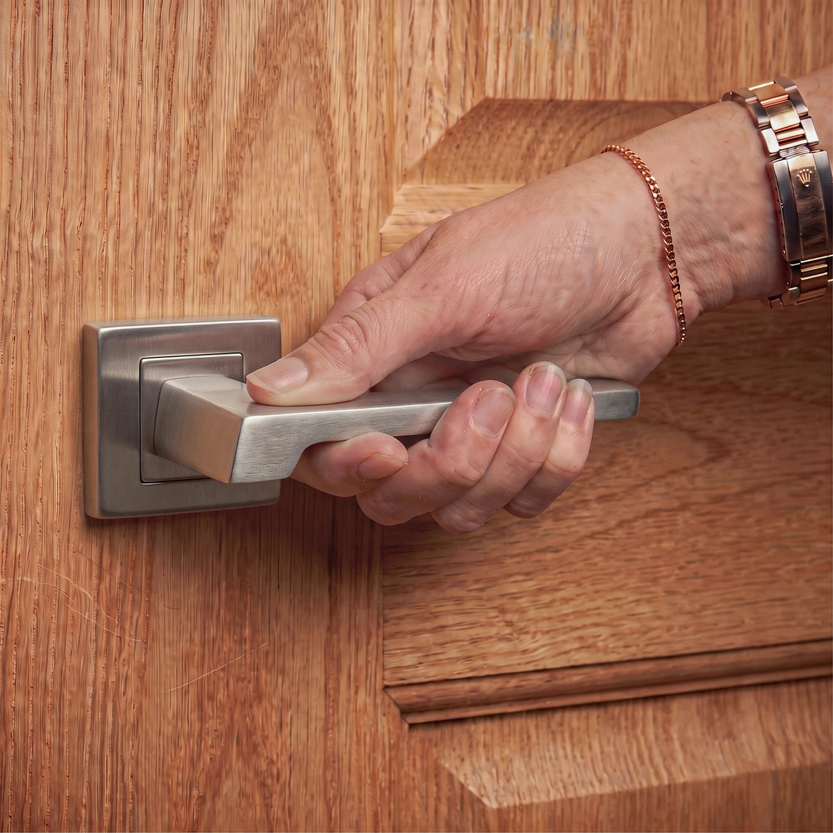 Spectra Satin Nickel Door Lever Handles – held in hand to show the size and finish