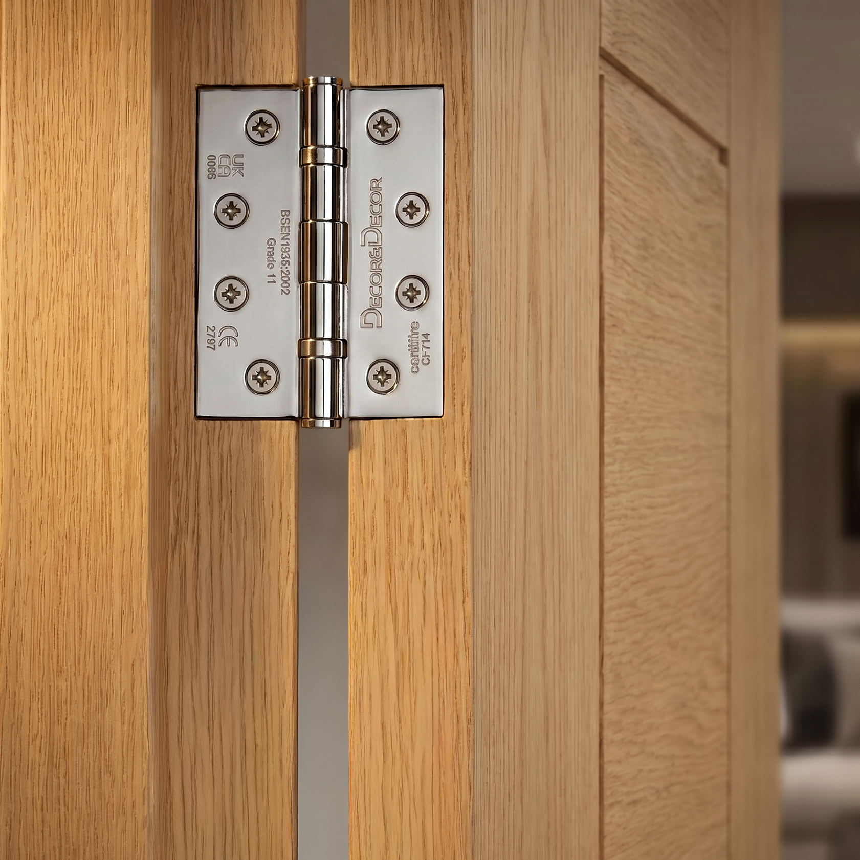 Close-up of a wooden door with a metallic hinge, featuring the Decoranddecor Door hinge brand.