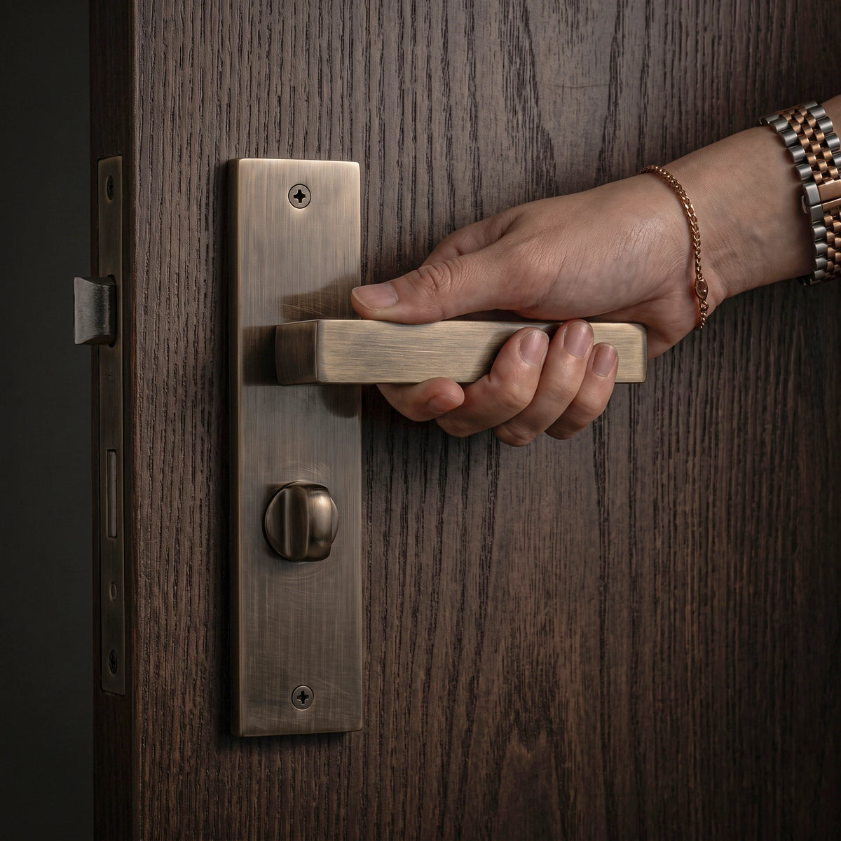 Lumina Antique Brass Door Lever Handles on Backplate – held in hand to show the size and finish