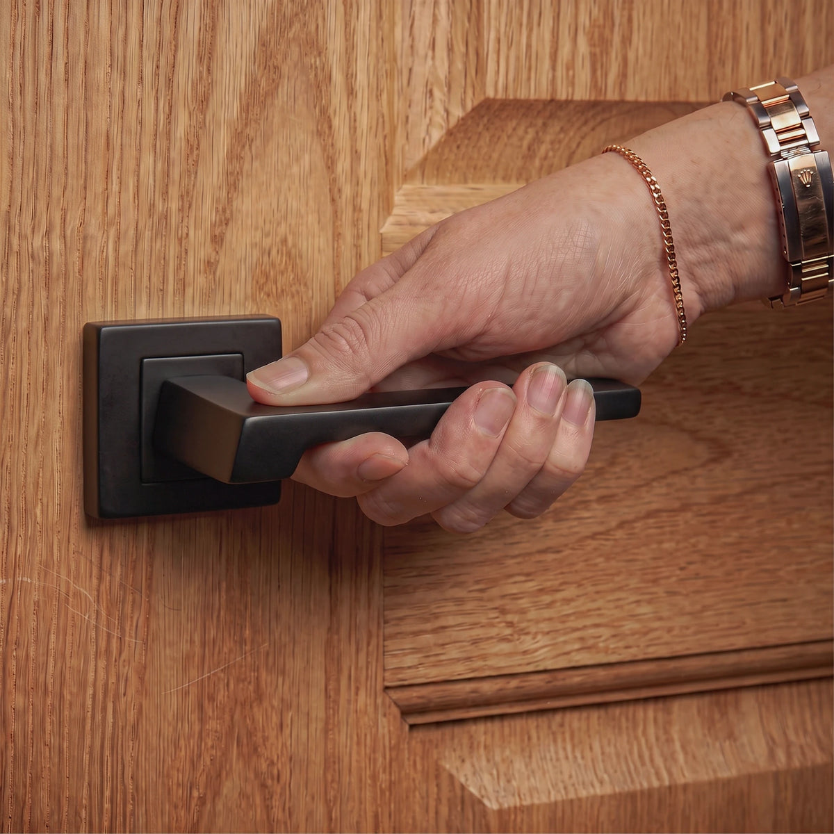 Spectra Matt Black Door Lever Handles – held in hand to show the size and finish