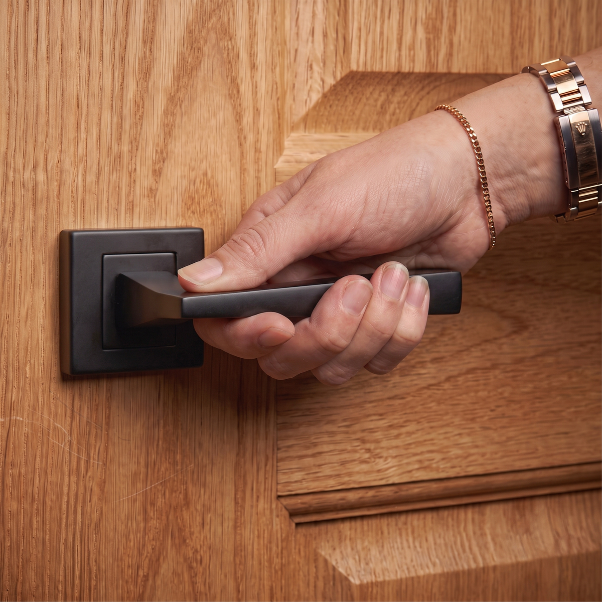 Helix Matt Black Door Lever Handles – held in hand to show the size and finish