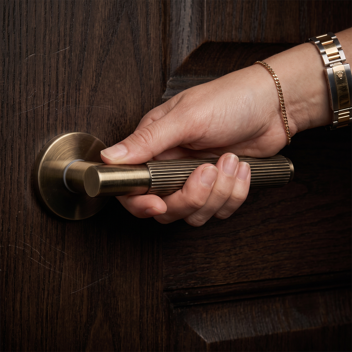 Hera Antique Brass Door Lever Handles – held in hand to show the size and finish