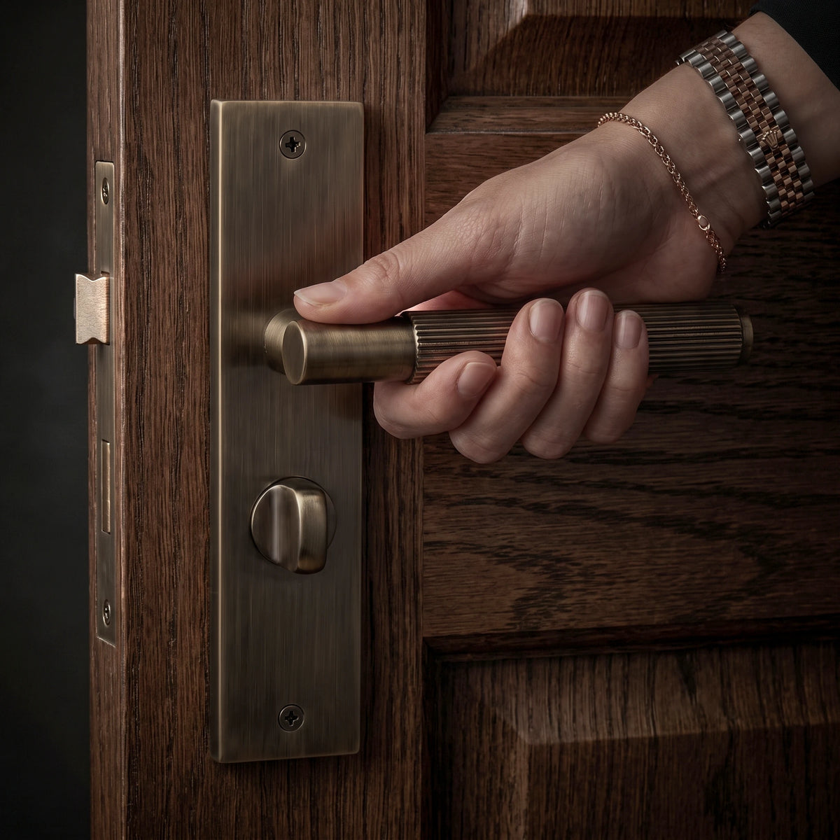 Hera Antique Brass Bathroom Door Handles on Backplate – held in hand to show the size and finish