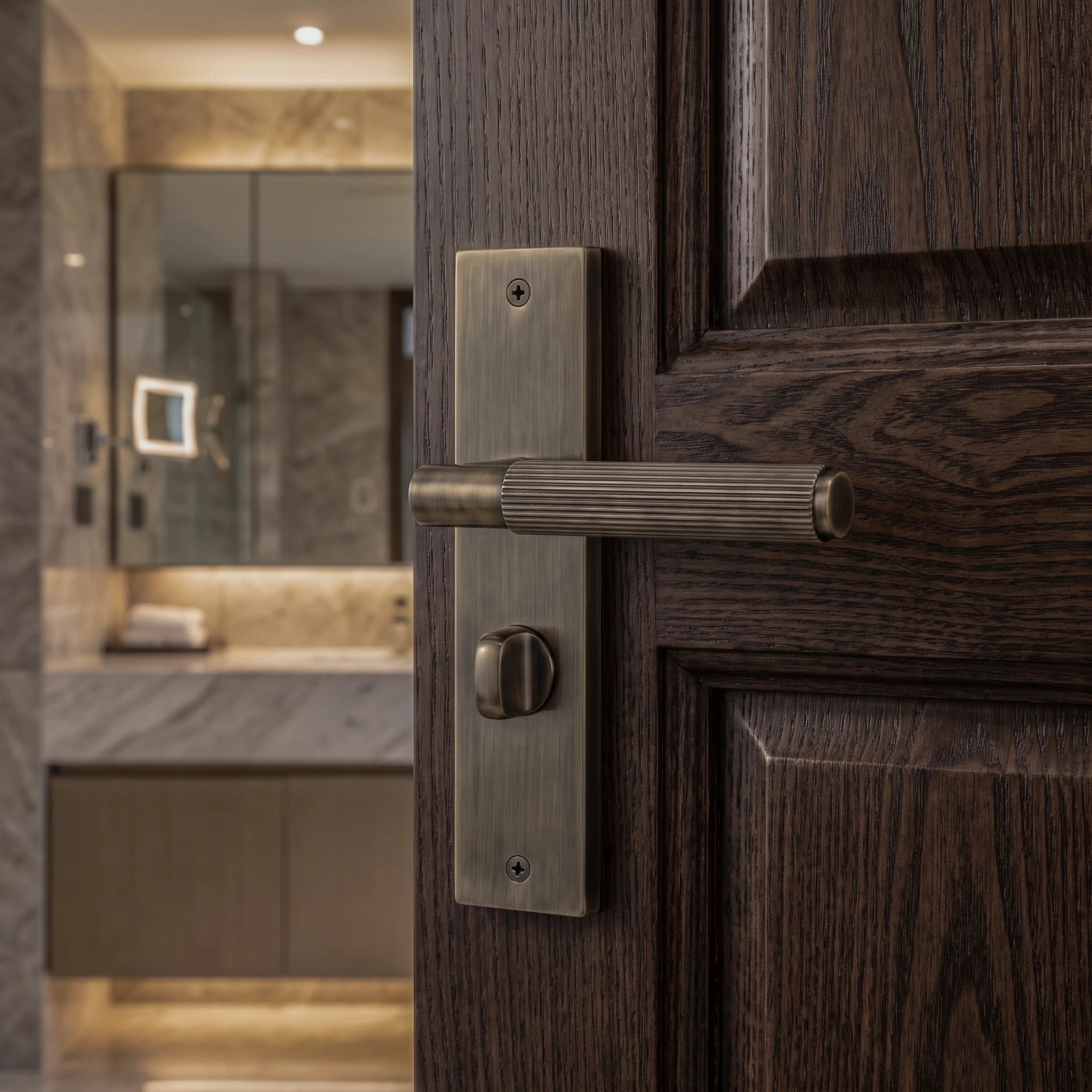 Hera Antique Brass Bathroom Door Handles on Backplate – fitted on an interior door in a styled room setting 2