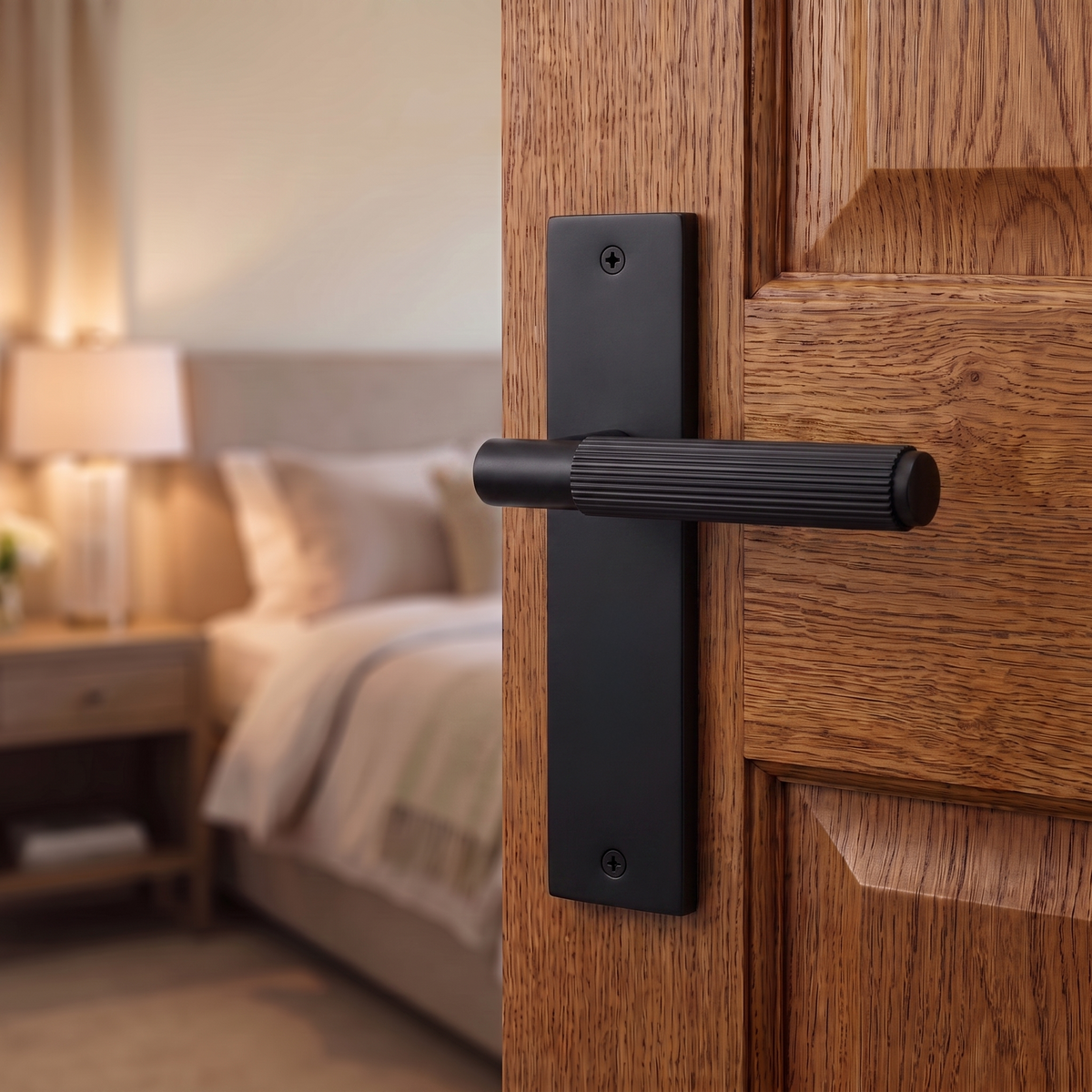Hera Matt Black Door Lever Handles on Backplate – fitted on an interior door in a styled room setting 2