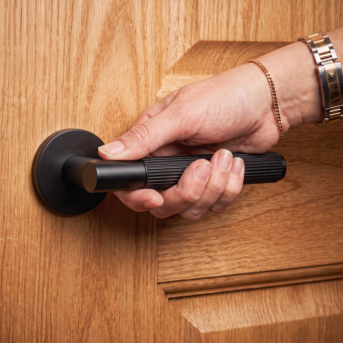 Hera Matt Black Passage Door Lever Handles – held in hand to show the size and finish
