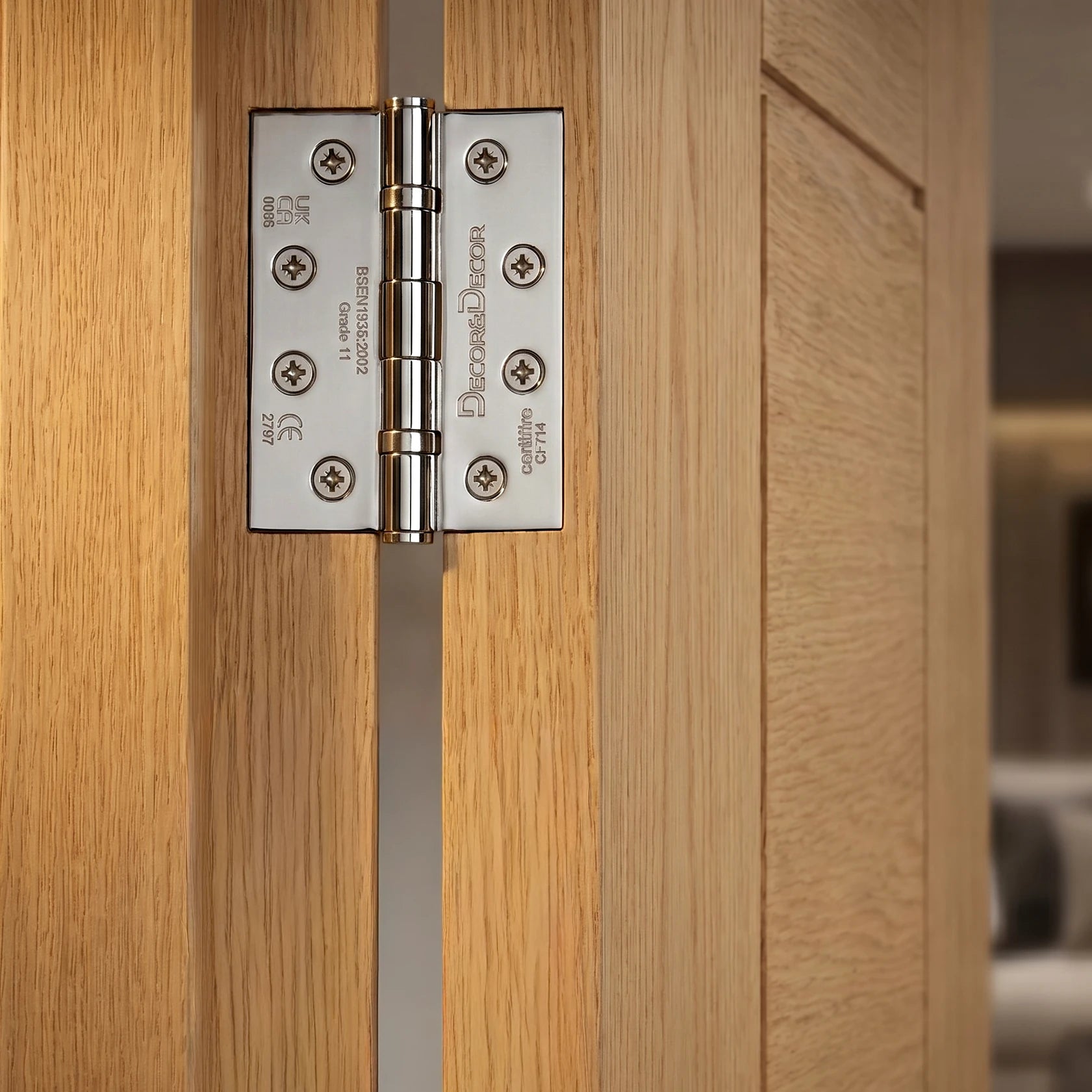 Close-up of a wooden door with a metallic hinge, featuring the Decoranddecor Door hinge brand.