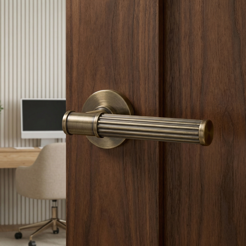 Leto Antique Brass Privacy Door Lever Handles – fitted on an interior door in a styled room setting