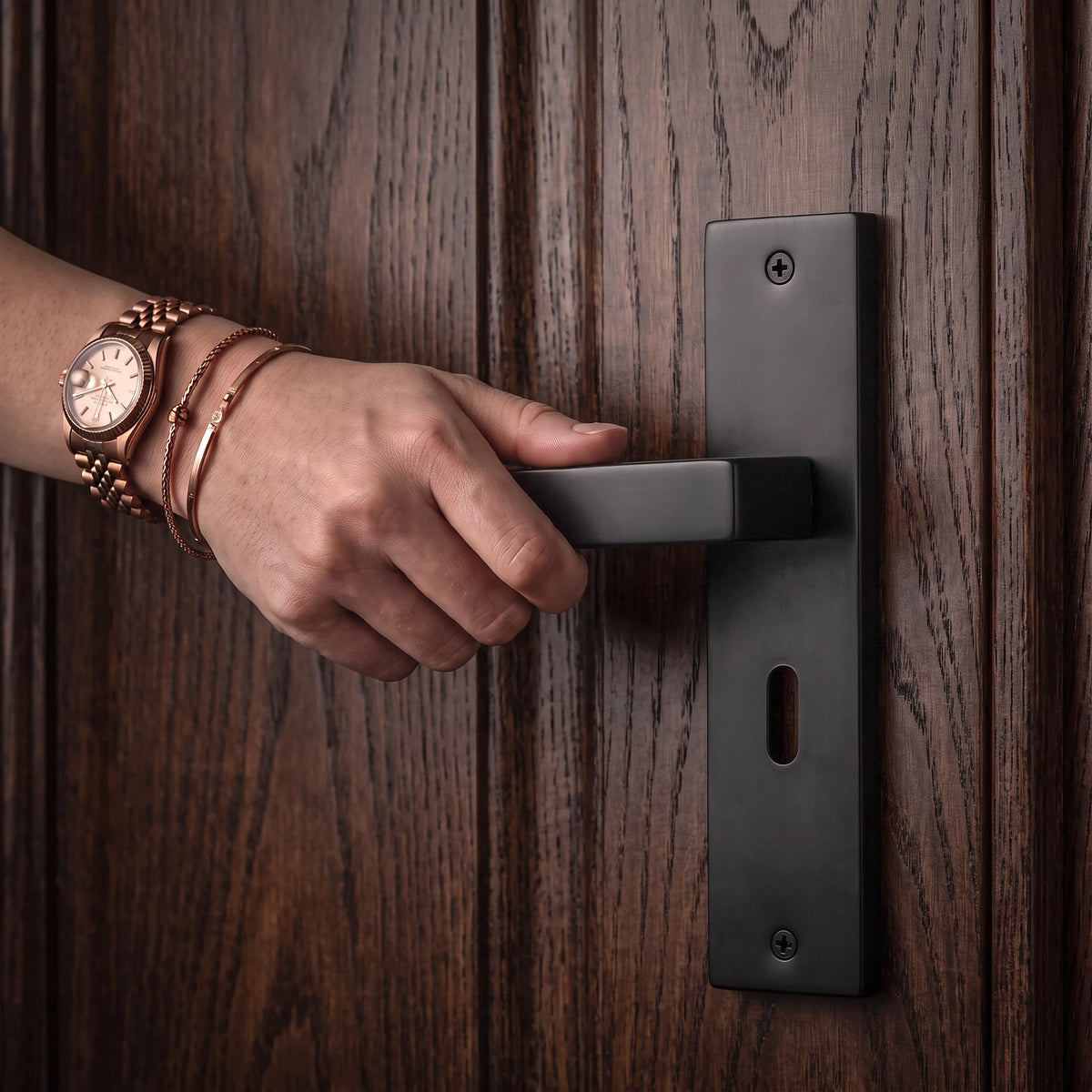Lumina Matt Black Door Lever Handles on Backplate – held in hand to show the size and finish