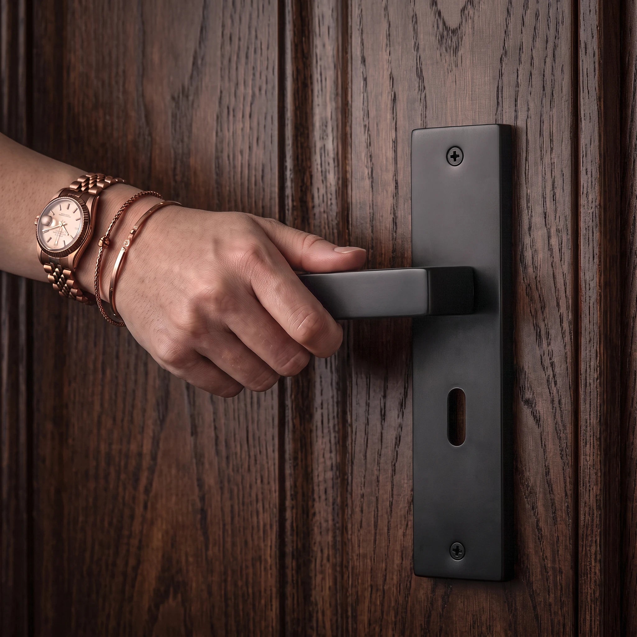 Lumina Matt Black Door Lever Handles on Backplate – held in hand to show the size and finish