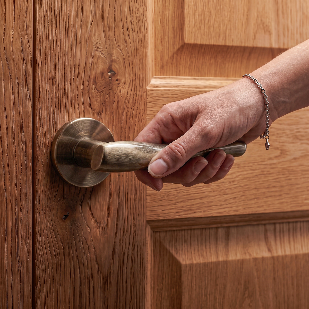 Nanda Antique Brass Door Lever Handles – held in hand to show the size and finish