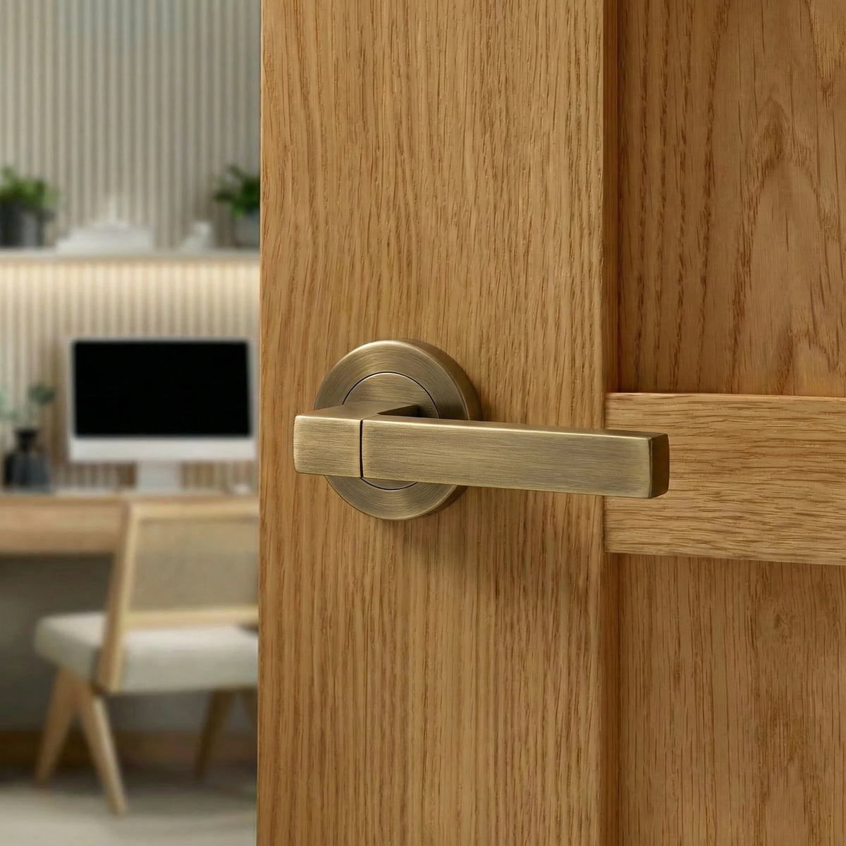 Lumina Antique Brass Door Lever Handles – fitted on an interior door in a styled room setting