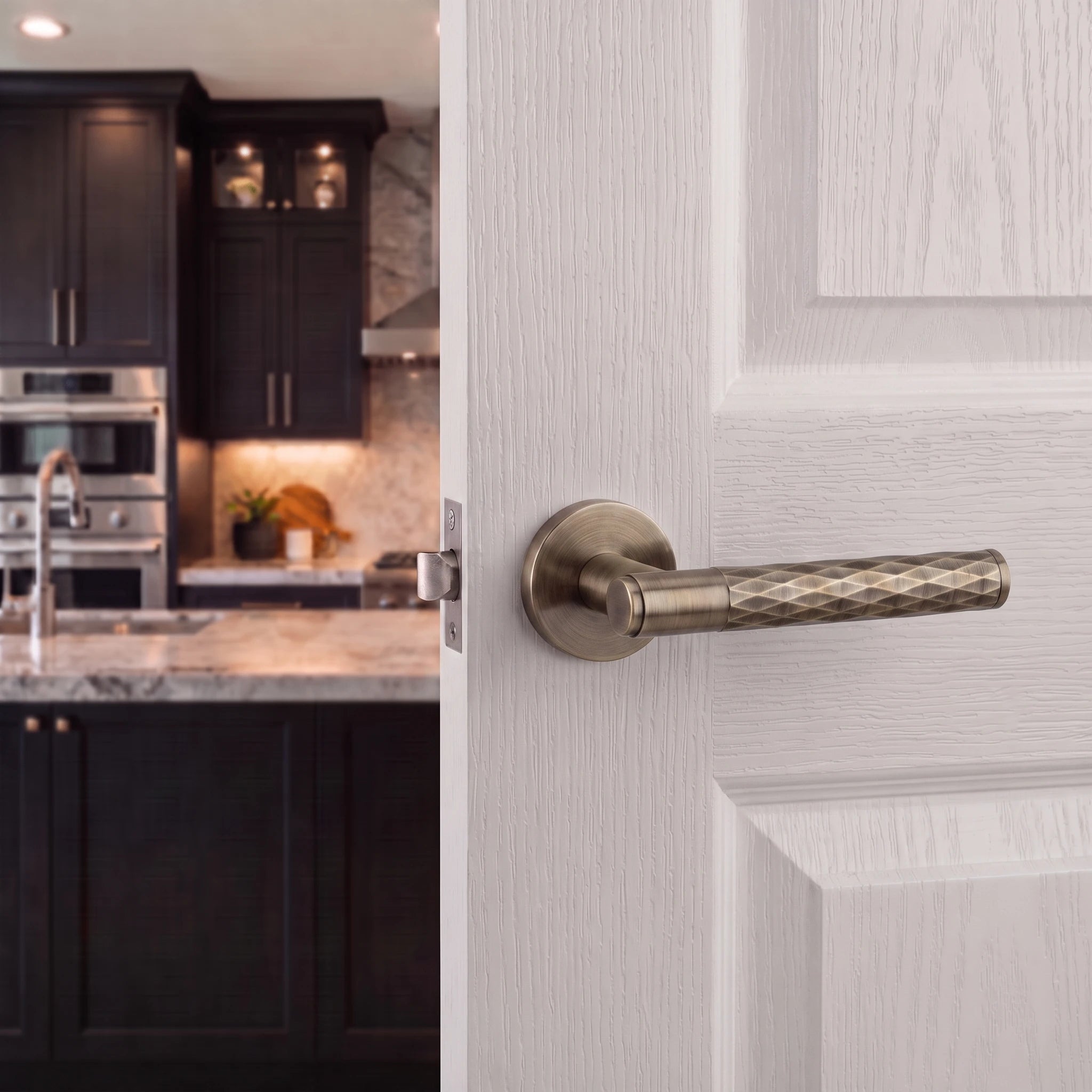 Tore Antique Brass Bathroom Door Handles – fitted on an interior door in a styled room setting 4
